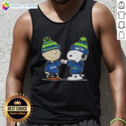 Alt Text: Charlie Brown and Snoopy fist bump in Seahawks gear on a football tank top, celebrating Peanuts fandom.