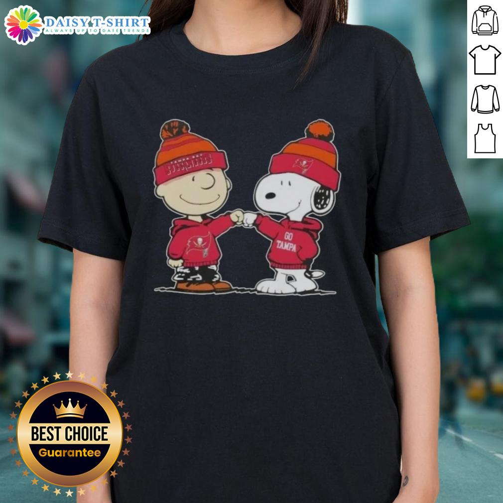 Charlie Brown and Snoopy fist bump on Tampa Bay Buccaneers football ladies tee, perfect for Peanuts fans and sports lovers.