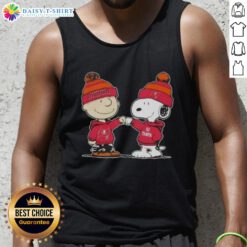 Charlie Brown and Snoopy fist bump in a Tampa Bay Buccaneers tank top featuring top peanuts design.