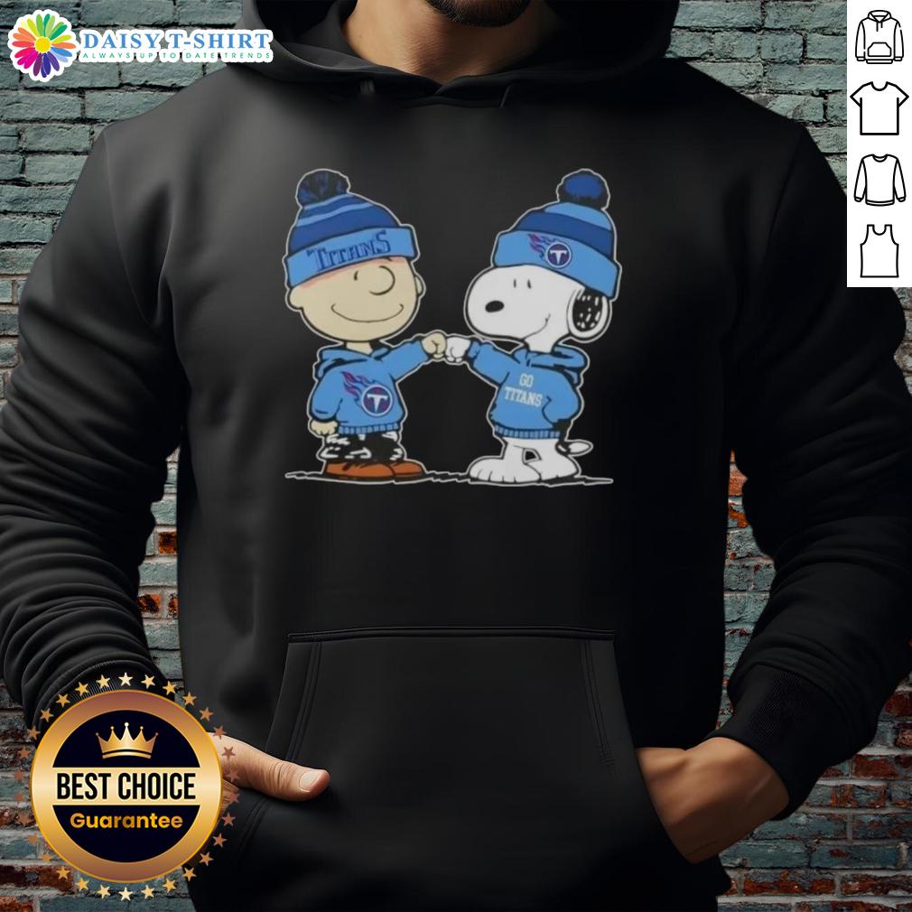 Alt Text: Charlie Brown fist bumps Snoopy, both wearing a Tennessee Titans football hoodie, celebrating Peanuts fandom.