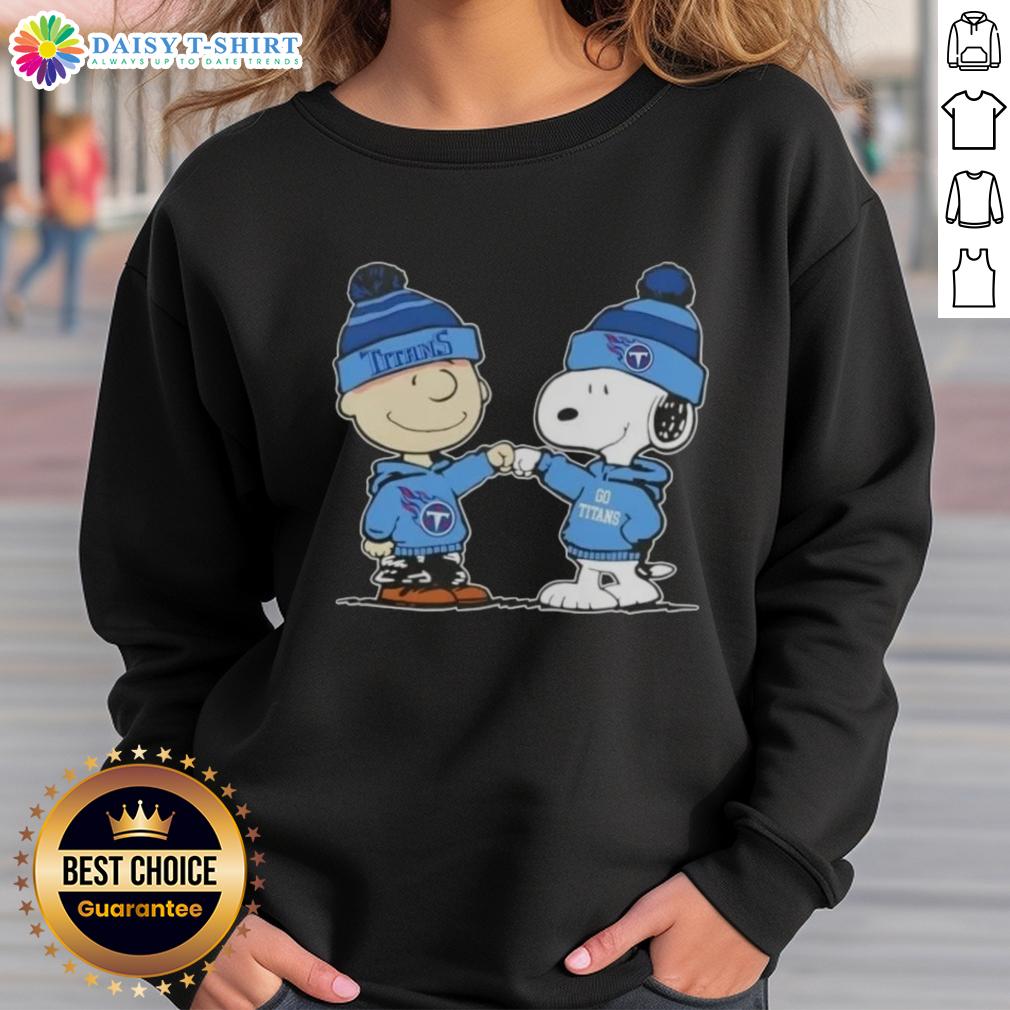 Charlie Brown and Snoopy fist bump in Tennessee Titans football sweatshirt, showcasing fun Peanuts teamwork spirit.