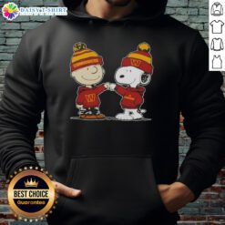 Alt Text: Charlie Brown and Snoopy fist bump in a Washington Commanders football hoodie, celebrating Peanuts fandom.