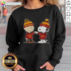 Charlie Brown fist bumping Snoopy in Washington Commanders football sweatshirt, perfect for Peanuts fans.