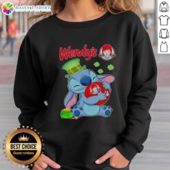 Cute Stitch hugging a St. Patrick's Day logo on a Wendy's sweatshirt, perfect festive wear for the holiday.