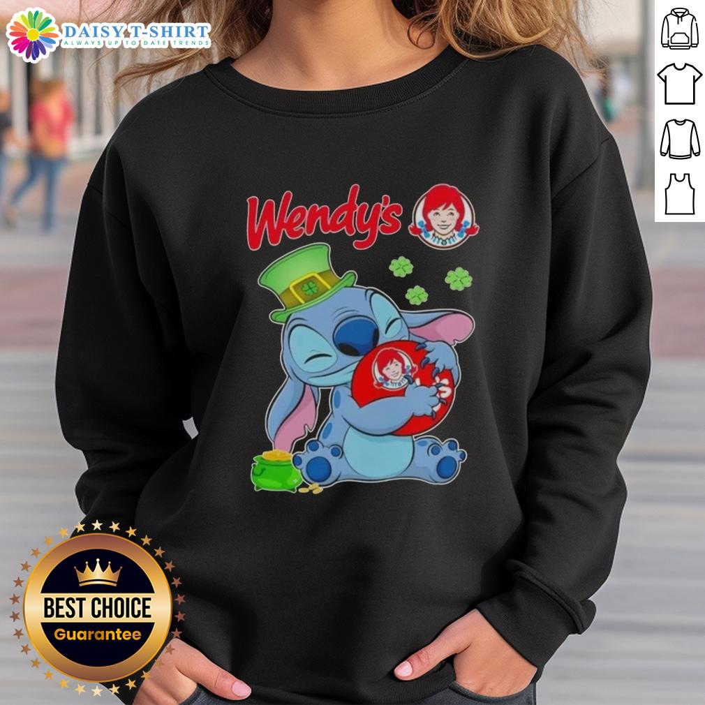 Cute Stitch hugging a St. Patrick's Day logo on a Wendy's sweatshirt, perfect festive wear for the holiday.
