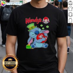 Alt Text: Cute Stitch character hugging Wendy's logo on a St. Patrick's Day themed t-shirt design, perfect for festive celebrations.