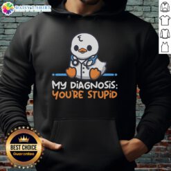Pretty doctor in a humorous 'You're Stupid' hoodie, playfully diagnosing a patient with a smile in a bright clinic.
