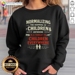 Original sweatshirt featuring 'Normalizing the Harming of Children Anywhere is a Threat to Children Everywhere' message.