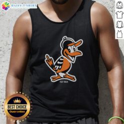 Hot Zay wearing Baltimore Orioles mascot tank top, celebrating team spirit since 1954 at a lively outdoor event.