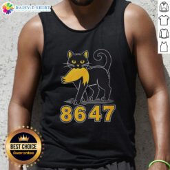 Good black cat wearing an anti-Trump tank top, showcasing a playful and bold political statement in a vibrant setting.