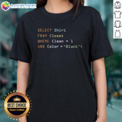 A woman selecting a clean black ladies tee from a neatly organized closet, showcasing stylish fashion choices.