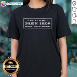 Alt Text: Official Uncle Sam's Pawn Shop display featuring luggage, jewelry, and shotguns on a ladies' tee shirt.