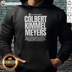 Top USA hoodie featuring 'The World Is Watching' design, inspired by Colbert, Kimmel, and Meyers.