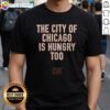 Hot The City Of Chicago Is Hungry Too CHI Chicago Bears NFL Shirt displayed on a flat lay background