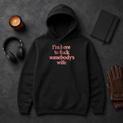 Hot I'M Here To Fuck Somebody'S Wife Hoodie in black, featuring bold white text on front, cozy pullover style with front pocket