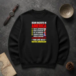 Official Dear Racists In America You Live On Is Native American Sweater in charcoal gray, front view with bold white text design