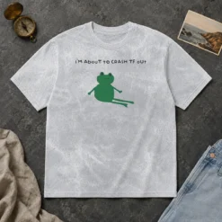 Original Frog I Am About To Crash Tf Out Meme printed on a soft washed t shirt in light gray